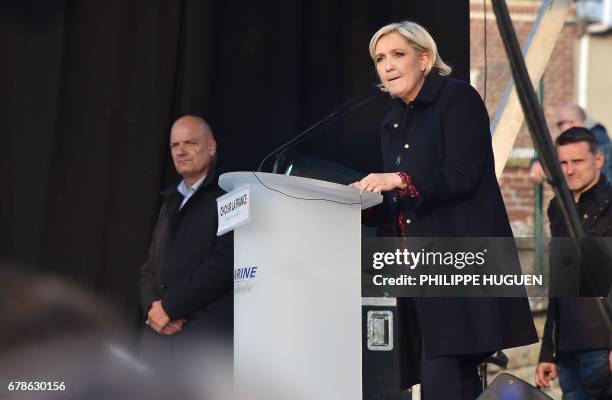 French presidential election candidate for the far-right Front National party, Marine Le Pen , next to her bodyguard Thierry Legier , delivers a...