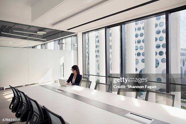 businesswoman using laptop in conference room - frau business glas modern stock-fotos und bilder