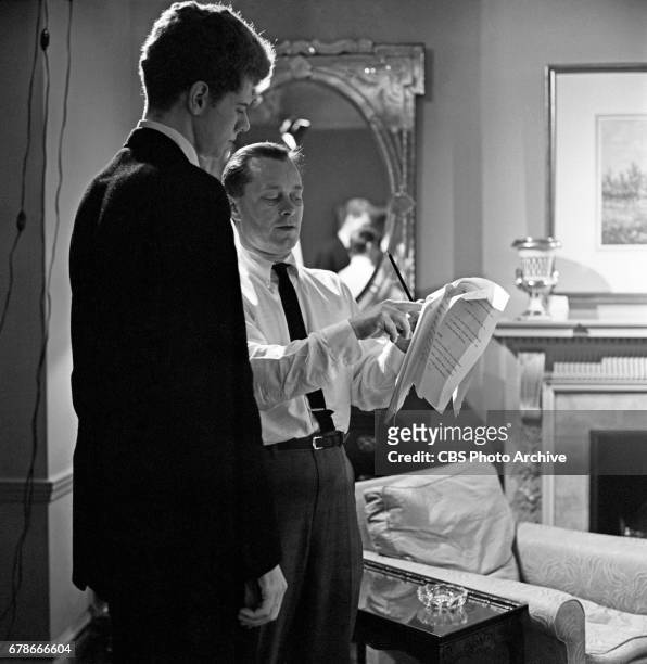 Pianist Van Cliburn is photographed for the CBS interview program "Person to Person" in his suite at the Hotel Pierre in New York City as members of...