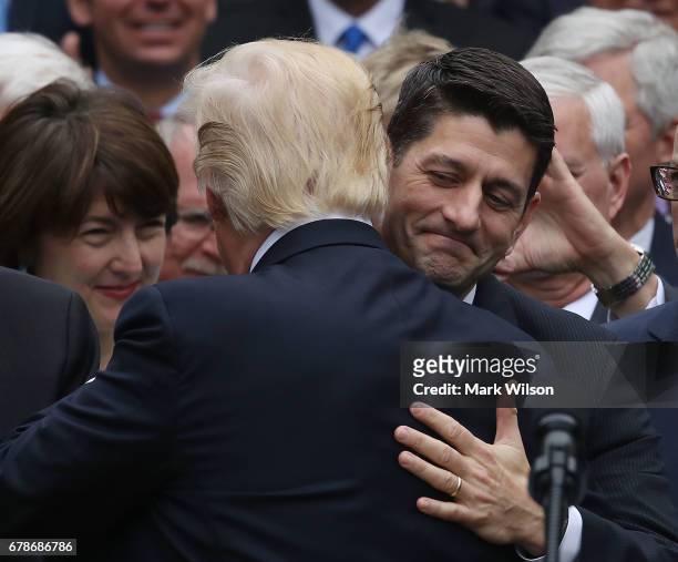 President Donald Trump congratulates House Speaker Paul Ryan , after Republicans passed legislation aimed at repealing and replacing ObamaCare,...