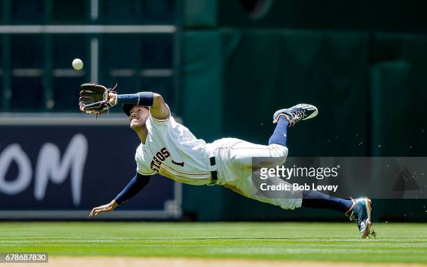 Carlos Correa of the Houston Astros makes a diving catch on a pop fly by Nomar Mazara of the Texas Rangers in the fourth inning at Minute Maid Park...