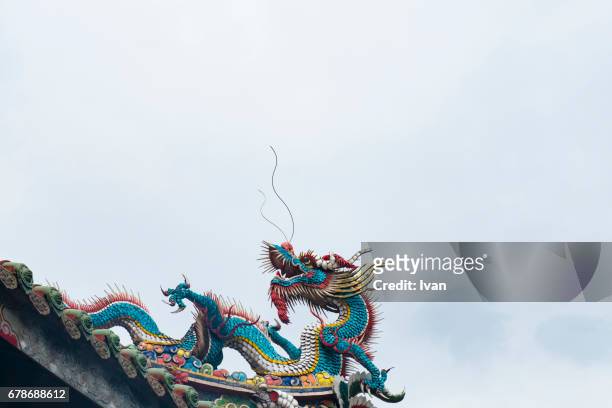 chinese dragon in front of blue sky - chinese dragon stock pictures, royalty-free photos & images