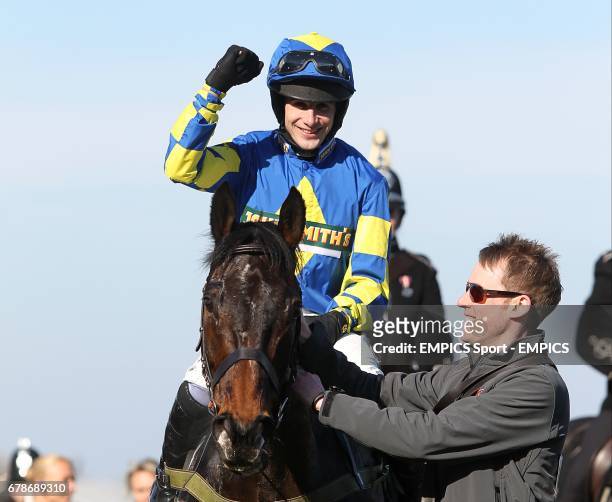 Ryan Mania celebrates on Auroras Encore after winning the John Smith's Grand National Chase during Grand National Day at Aintree Racecourse,...