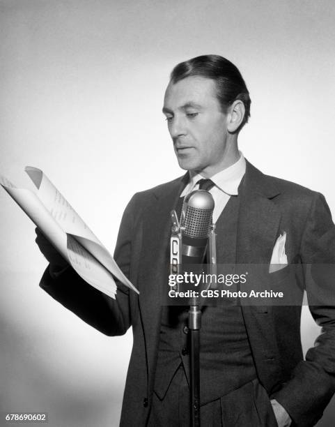 Gary Cooper poses for a photo at a microphone for The CBS Radio program, "Screen Guild Theater." This broadcast was a performance of an original...
