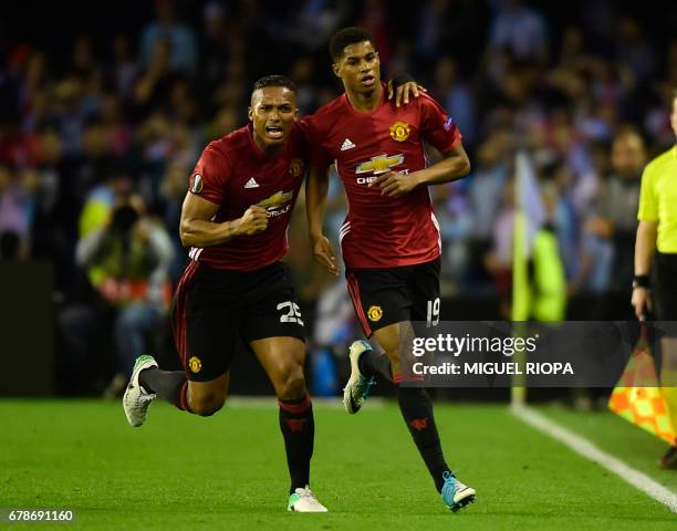 Manchester United's forward Marcus Rashford celebrates with his teammate Ecuadorian defender Antonio Valencia after scoring during their UEFA Europa...