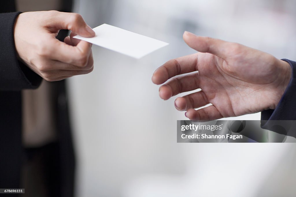 Hands Of Business People Giving Business Card High-Res Stock Photo - Getty  Images