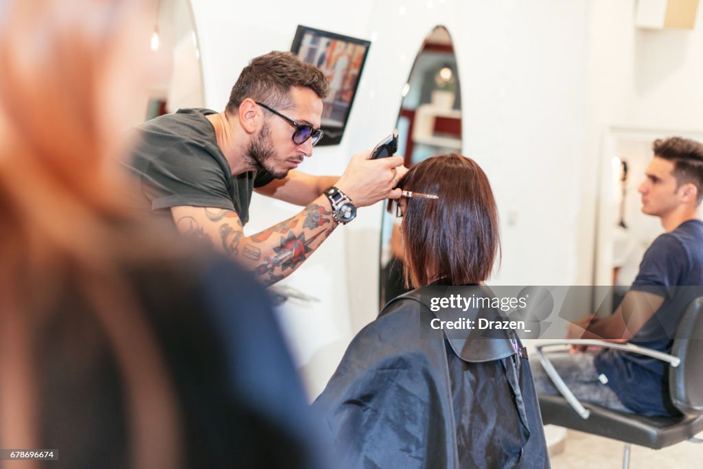 Beautiful woman in hair salon, having her hair cut