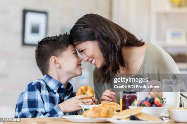 mom and son enjoy breakfast together - mother son milk imagens e fotografias de stock