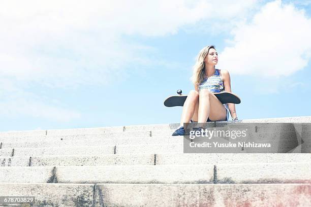 girl with skateboard - women in daisy dukes stock-fotos und bilder