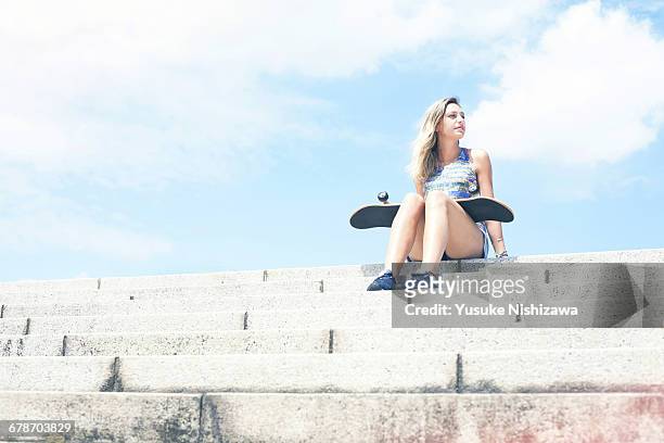 girl with skateboard - women in daisy dukes stock pictures, royalty-free photos & images