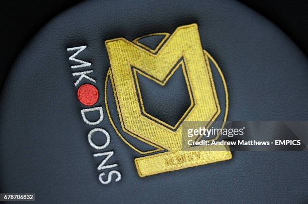 General view of a club badge of Milton Keynes Dons embroidered into a chair in the dug-out