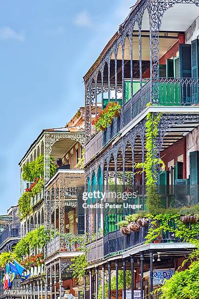 the wrought iron lace of a french quarter balcony - new orleans stock-fotos und bilder