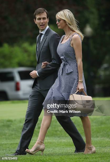White House Senior Adviser Jared Kushner walks with his wife Ivanka Trump as they depart with President Donald Trump on Marine One at the White House...