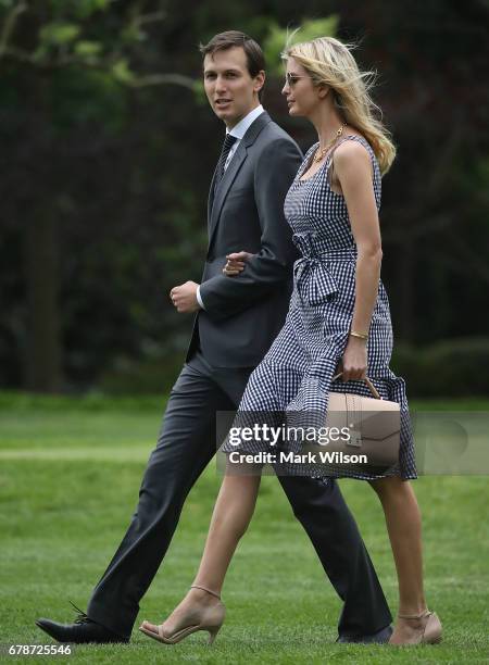 White House Senior Adviser Jared Kushner walks with his wife Ivanka Trump as they depart with President Donald Trump on Marine One at the White House...