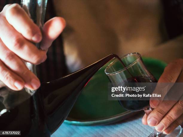 serving red wine into glass - wine glass finger food stock-fotos und bilder