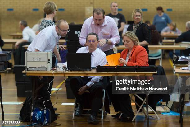 Officials gather around a laptop at Llanishen Leisure Centre on May 4, 2017 in Cardiff, Wales. A total of 4,851 council seats are up for grabs in 88...