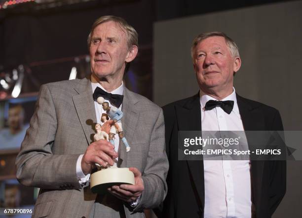 Sir Alex Ferguson and Eric Harrison on stage collecting their PFA Merit award during the PFA Player of the Year Awards 2013 at the Grosvenor House...