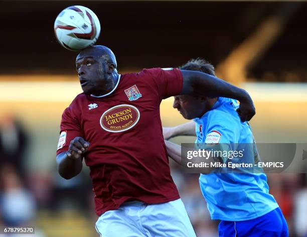 Northampton Town's Adebayo Akinfenwa and cheltenham Town's Steve Elliott