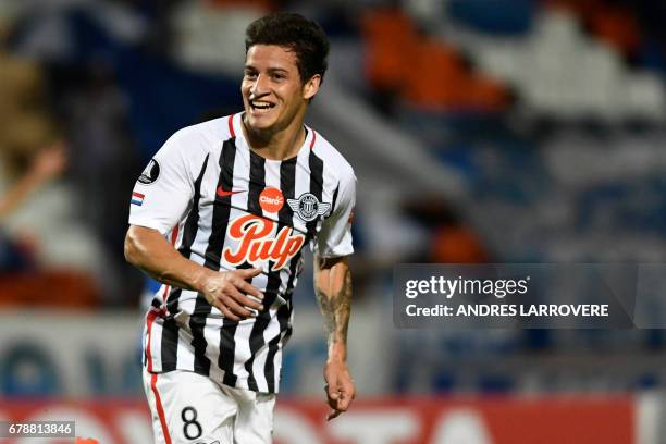 Paraguay's Libertad player Danilo Santacruz celebrates after scoring his first goal against Argentina's Godoy Cruz during their Copa Libertadores...