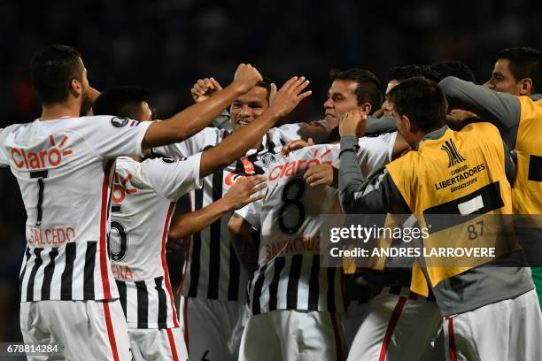 Paraguay´s Libertad player Danilo Santacruz celebrates with teammates after scoring his first goal against Argentina's Godoy Cruz during their Copa...