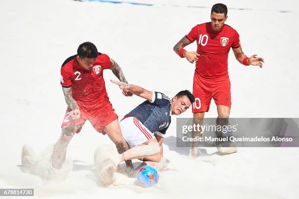 Carlos Carballo of Paraguay competes for the ball with Angelo Tchen of Tahiti and Tearii Labaste of Tahiti during the FIFA Beach Soccer World Cup...