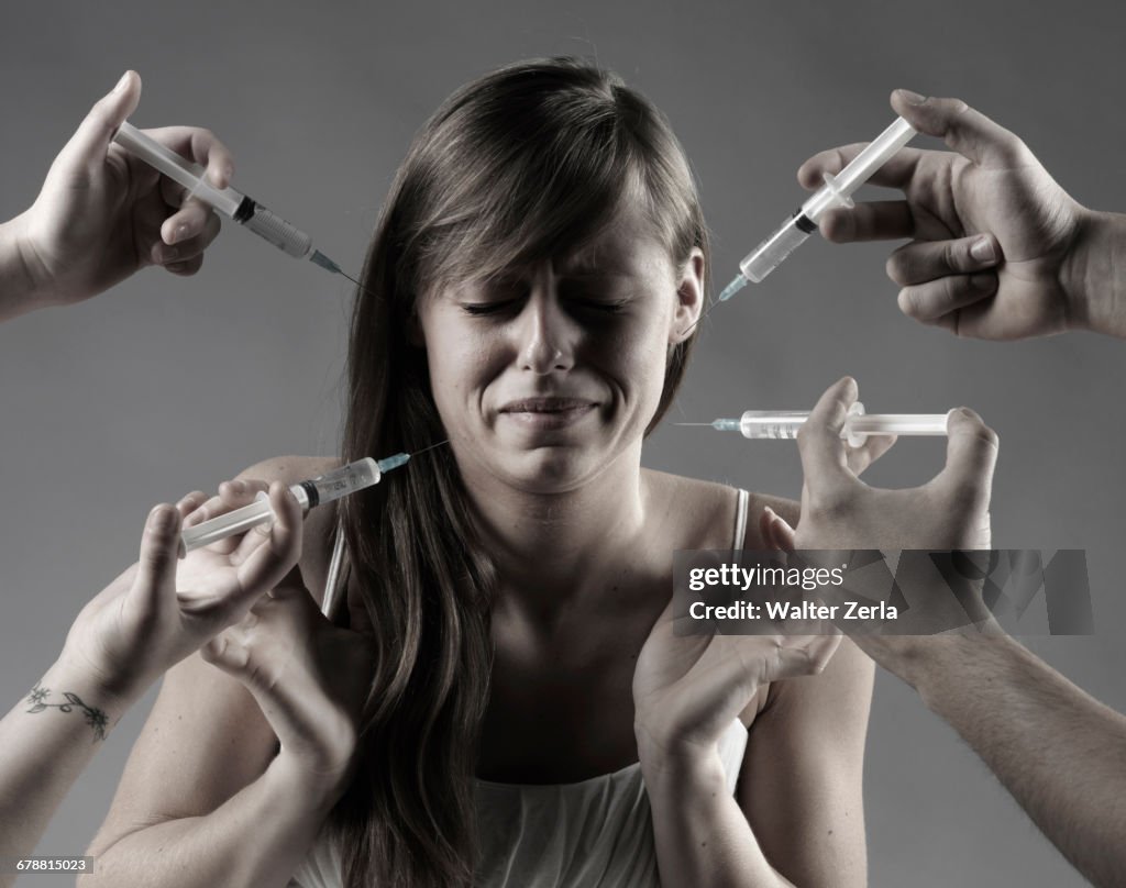 Caucasian woman fearing syringes