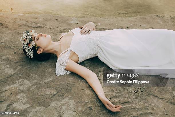 caucasian bride laying on beach - woman collapsing stock pictures, royalty-free photos & images