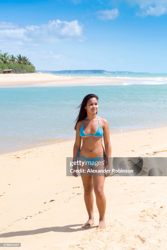Mixed Race girl standing on beach