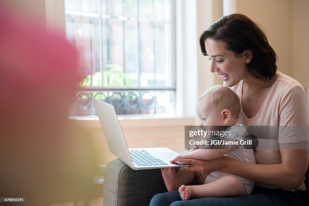 Baby Lap Computer Caucasian Mother Holding Baby In Lap Using Laptop Photo - Getty Images