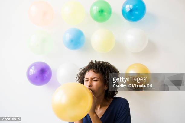 black woman inflating balloon - inflating ストックフォトと画像
