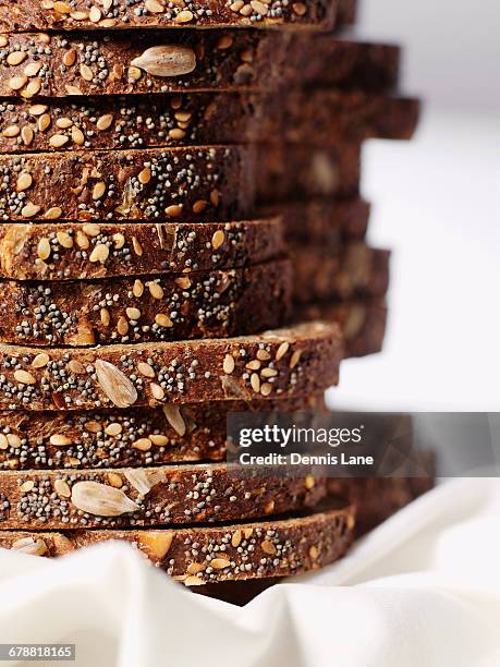 stack of organic sliced bread with seeds - sliced bread stock pictures, royalty-free photos & images