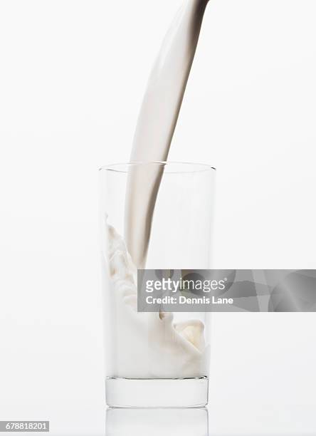 milk pouring into glass - almond milk stock-fotos und bilder