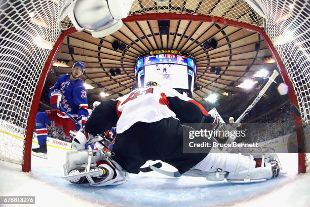 Nick Holden of the New York Rangers scores a first-period goal past Craig Anderson of the Ottawa Senators in Game Four of the Eastern Conference...