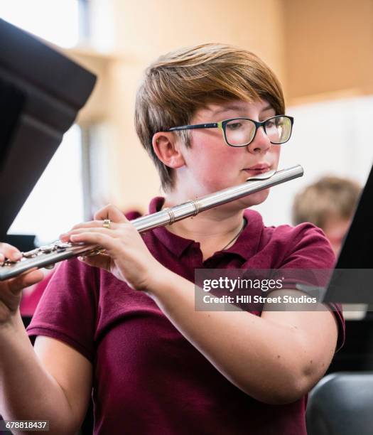 girl playing flute in music class - flauto foto e immagini stock