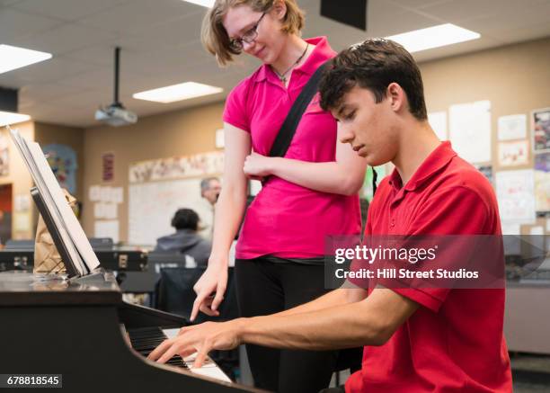 students playing piano in music class - pianist stock pictures, royalty-free photos & images