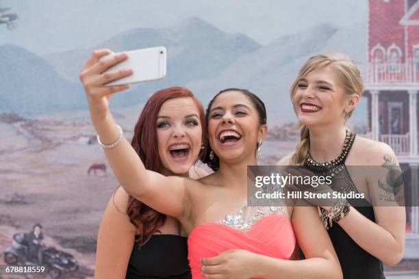 friends posing for cell phone selfie at prom - perfect moment stock pictures, royalty-free photos & images