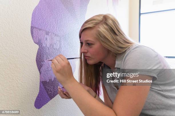 girl painting mural of map on school wall - art class stock pictures, royalty-free photos & images