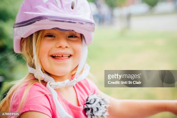 Smiling Mixed Race girl wearing helmet
