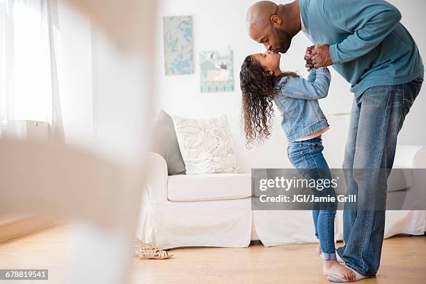 daughter standing on feet of father and dancing - kissing feet stock pictures, royalty-free photos & images