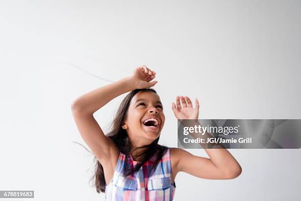 wind blowing hair of smiling mixed race girl - air child play stock-fotos und bilder