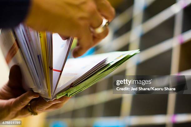 hands flipping through mail - post structure stock pictures, royalty-free photos & images