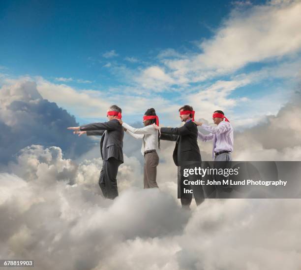 blindfolded businesspeople walking in clouds - restraining device stockfoto's en -beelden