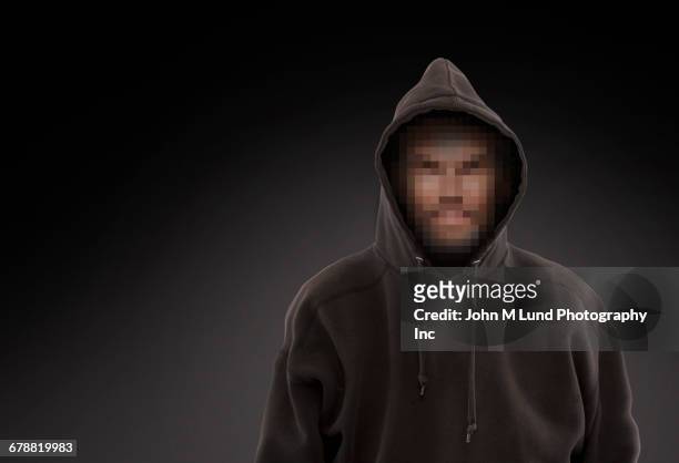 pixelated face of caucasian man wearing hooded sweatshirt - uomo incappucciato foto e immagini stock