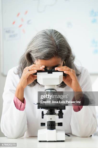 hispanic scientist using microscope - blick nach unten stock-fotos und bilder