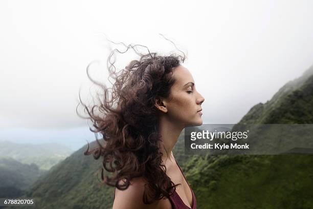 wind blowing hair of mixed race woman - vento foto e immagini stock