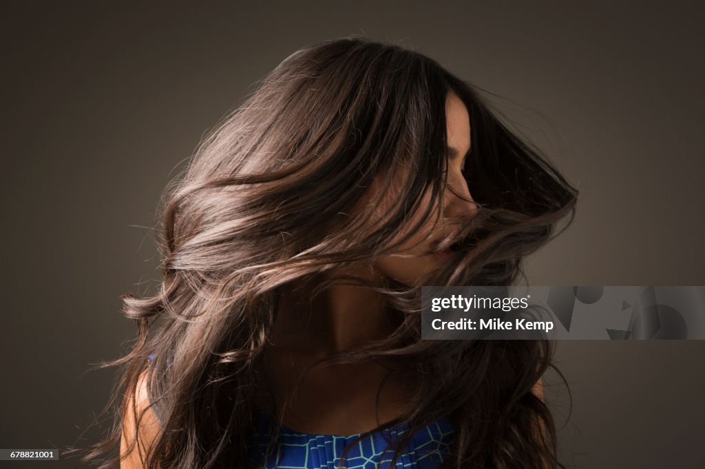 Mixed Race woman tossing hair