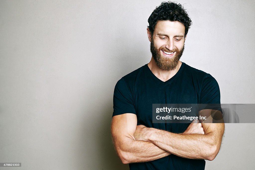 Smiling Caucasian man with beard looking down