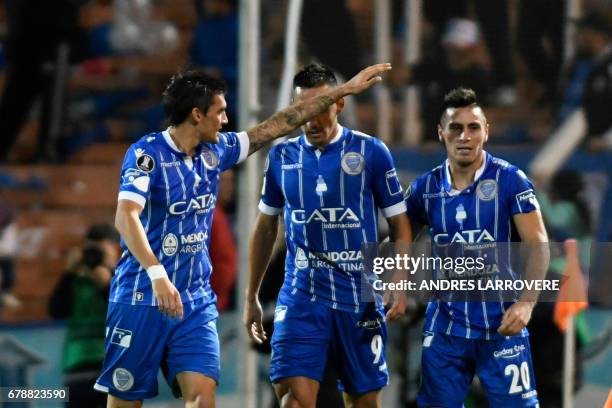 Argentina's Godoy Cruz player Juan Fernando Garro celebrates with teammates after scoring a goal against Paraguay's Libertad during their Copa...