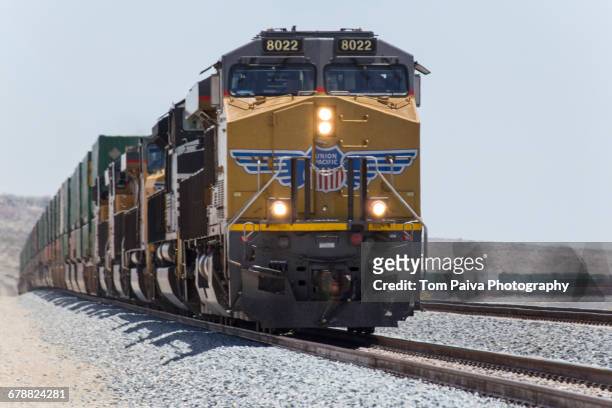 cargo train on railroad track - locomotive fotografías e imágenes de stock
