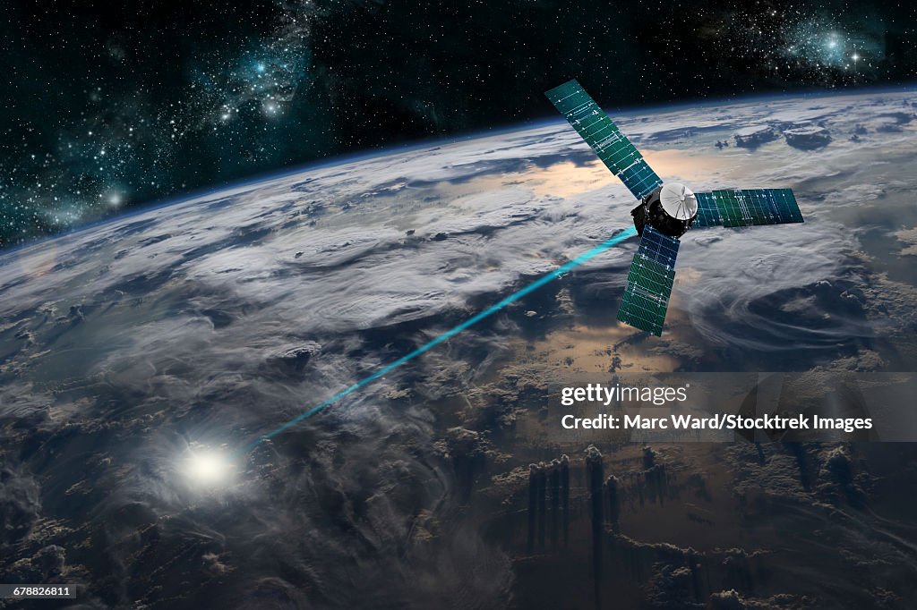 A composite image of a satellite firing an energy weapon at a target on Earth.
